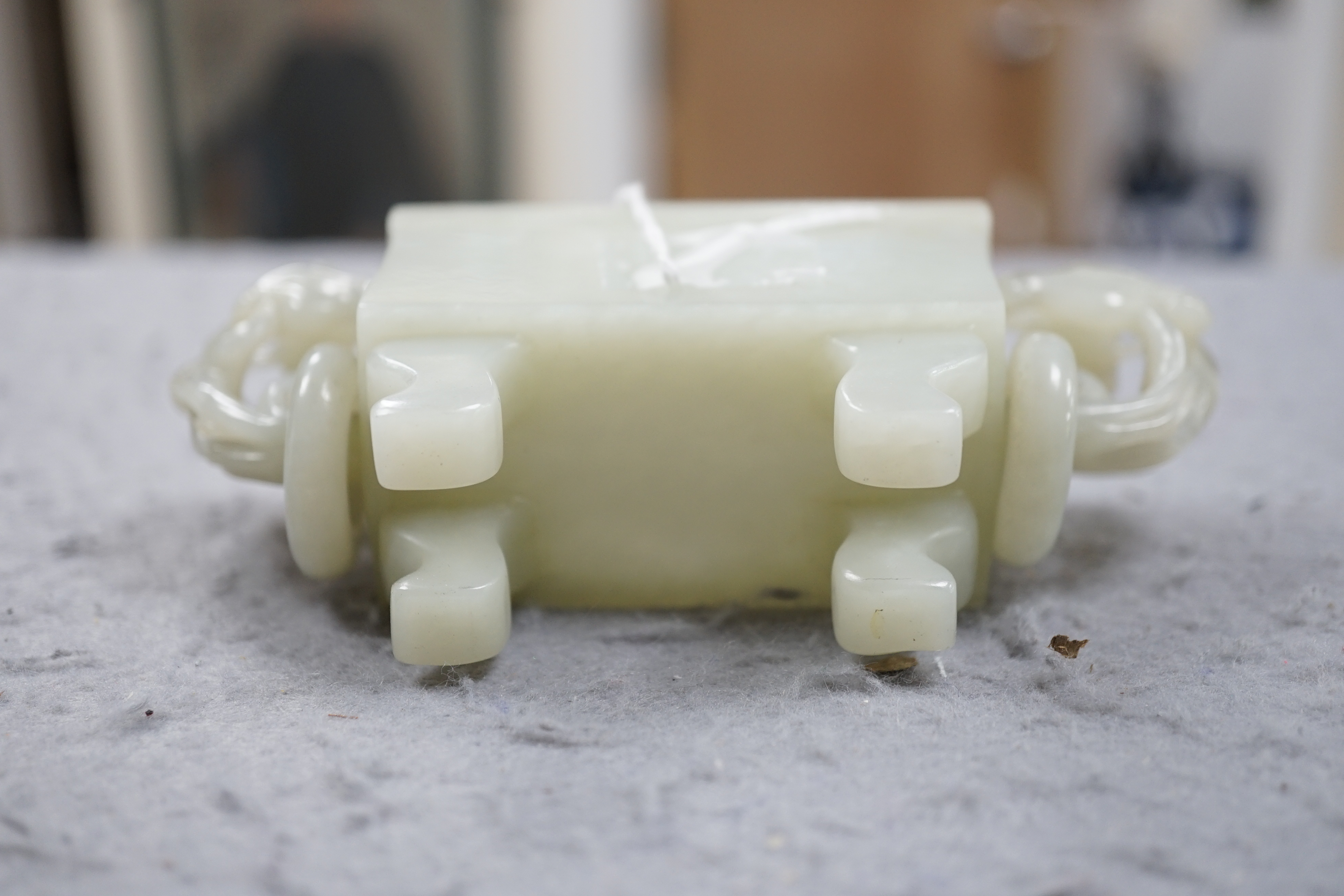 A Chinese pale celadon jade rectangular vase and cover, 19th/20th century